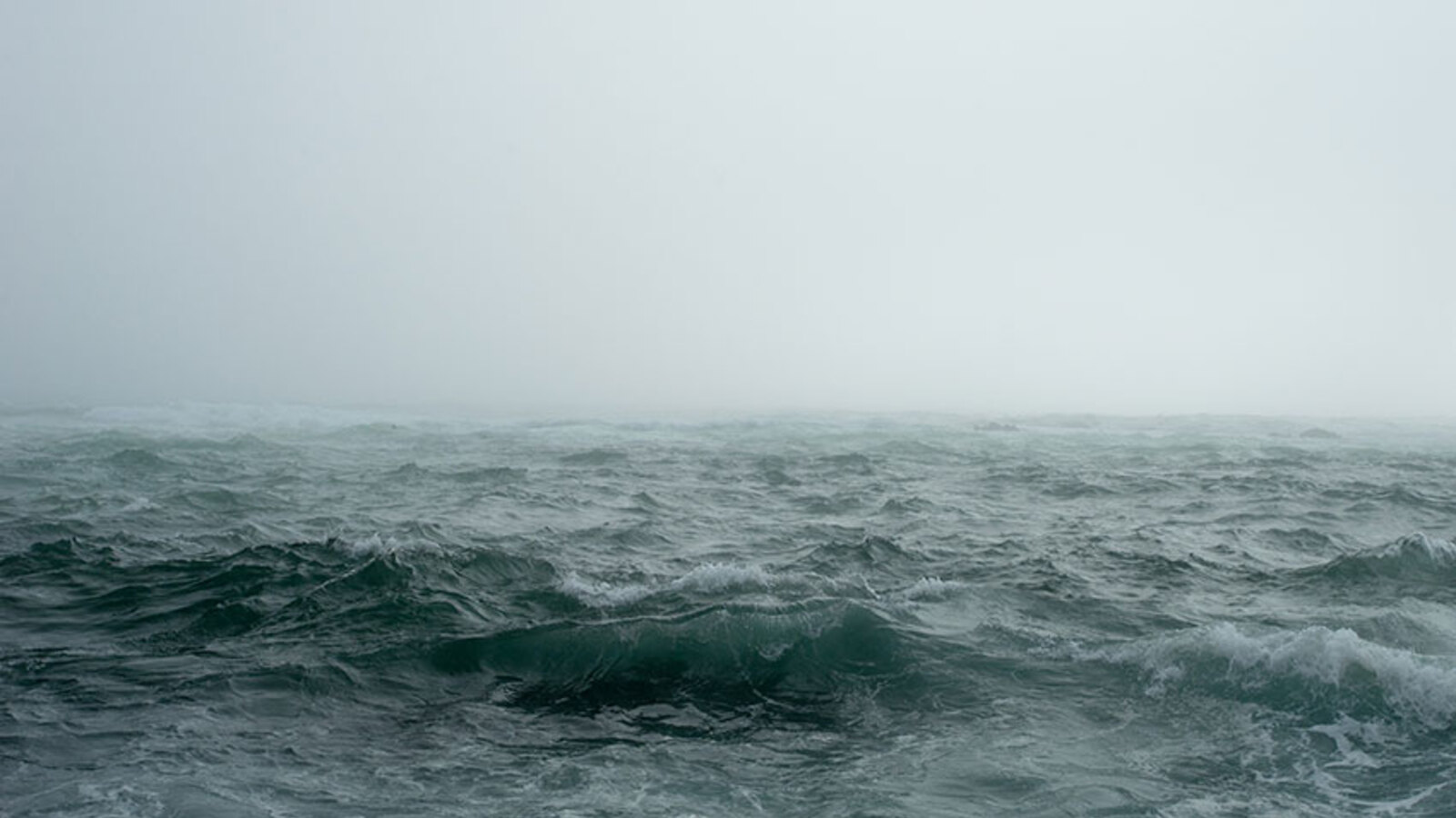 A choppy sea shrouded in fog, evoking the low-visibility conditions of the Solong and Stena Immaculate allision