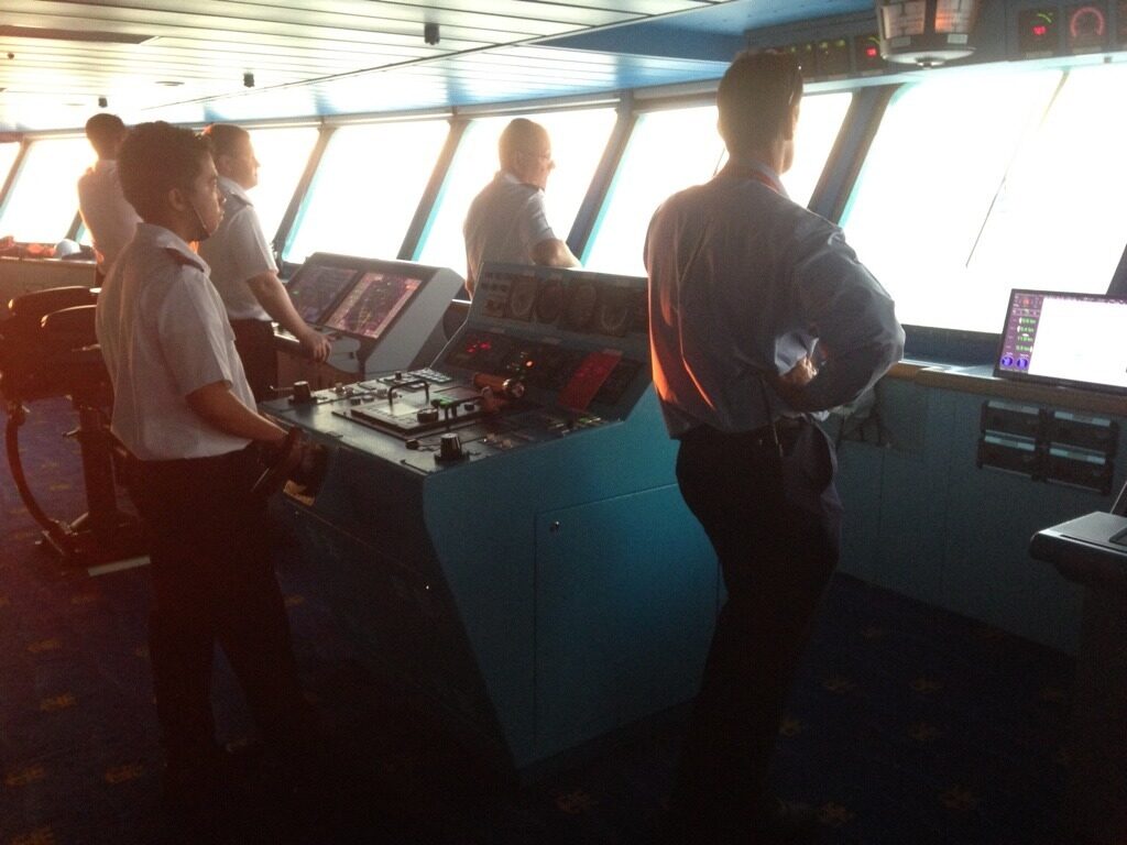 Bridge team working together at the ship’s navigation console